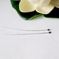 Argentium Long 60mm 2pcs Headpins Balled Flat laying flat on a white background flower on top.