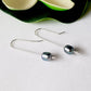 Argentium Long 60mm 2pcs Headpins Balled Flat sample, made into earrings, laying flat on a white background with a flower on top.