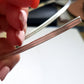 Close up view of the double half round wire held between fingers.