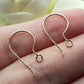 On a persons hand gold earring hook