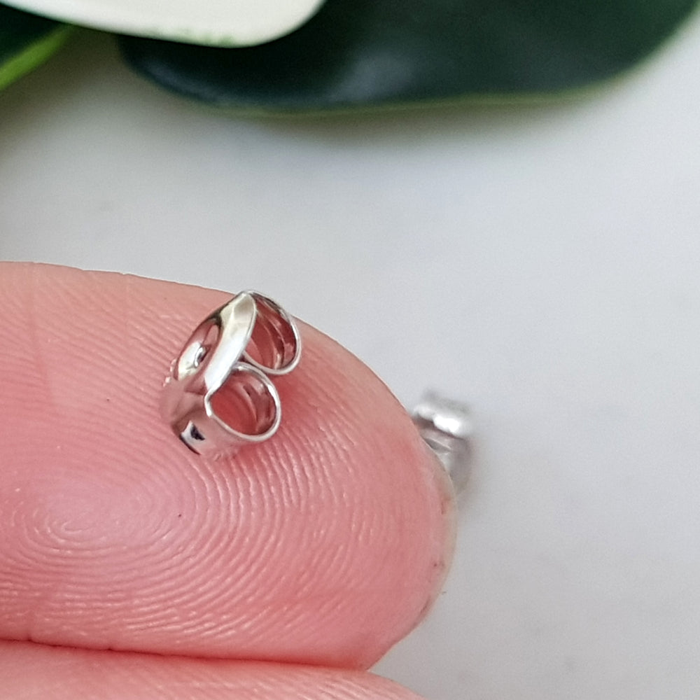 close up on a finger sterling silver 925 earring back