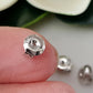 Close up on a finger sterling silver medium weight earring backs.
