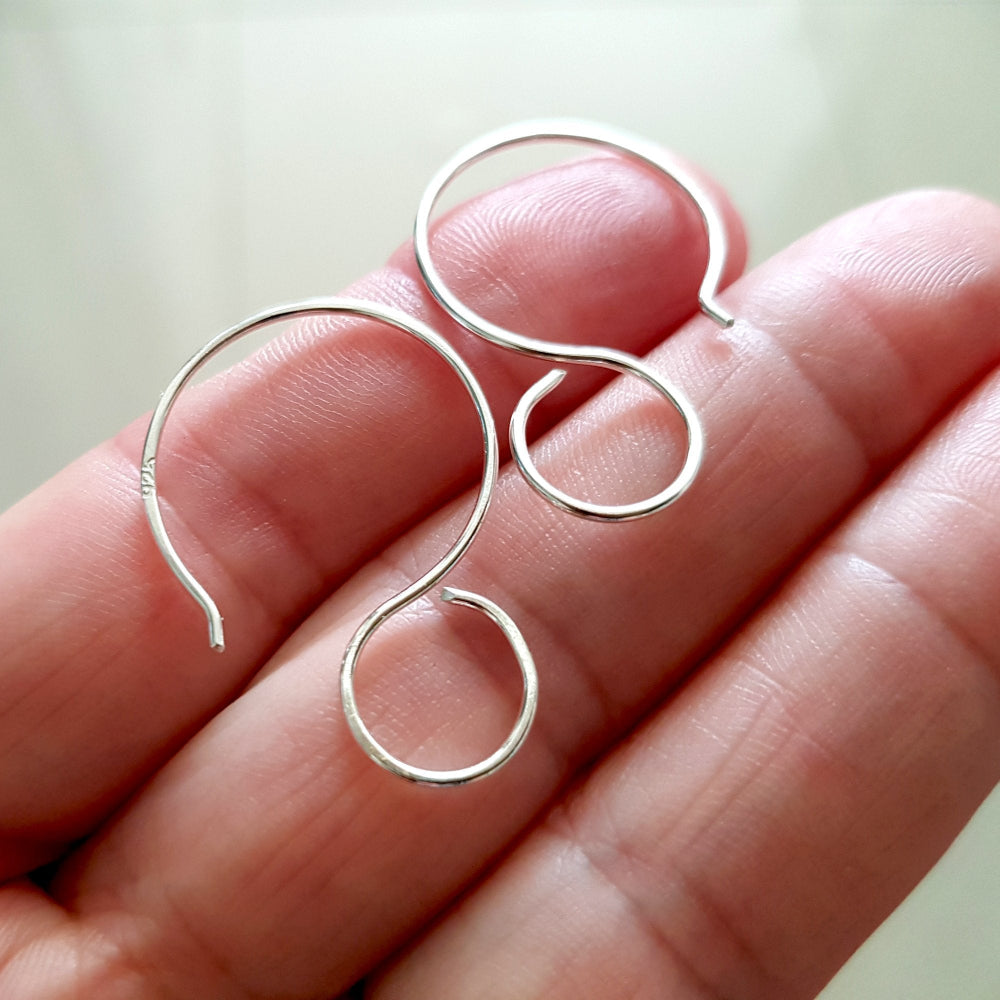 Premium Quality Sterling Silver on a hand blurred background.