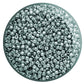A close-up view of blue slate galvanized round Toho seed beads. 11/0 TR-PF565 in a circle white background.