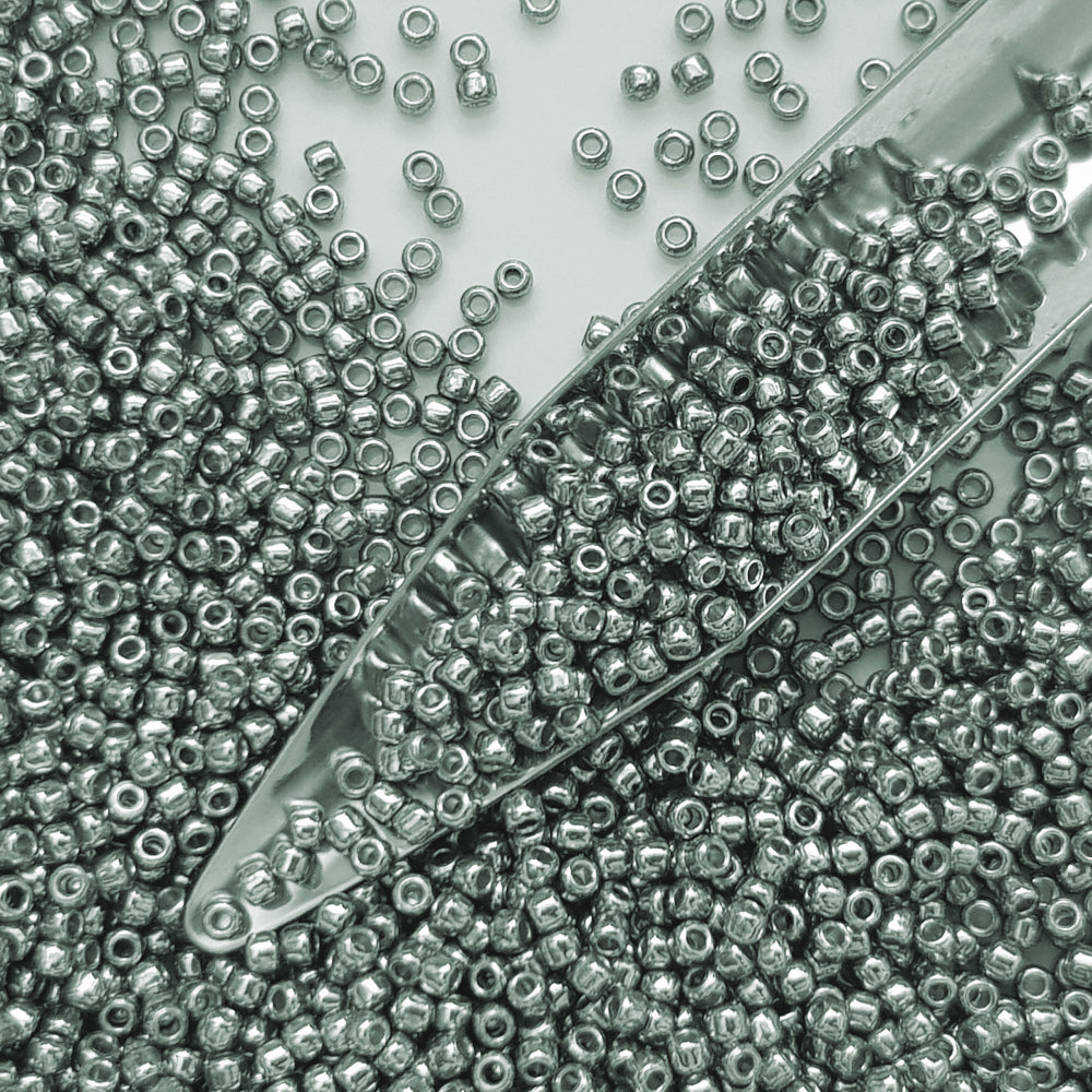11/0 Toho Seed Beads in blue slate galvanized TR-PF565 with a beading scoop.