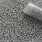 11/0 TR-53 Grey Opaque Round Toho Seed Beads - Beading Supply close up with a tube.