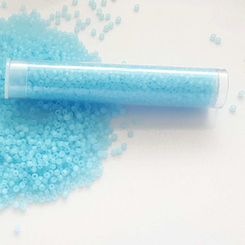 11/0 TR-143F Aqua Matte Ceylon Round Toho Seed Beads in a tube white background.