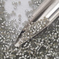 A collection of black diamond silver lined matte Toho round seed beads. 11/0 with a beading scoop