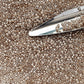 11/0 Toho Seed Beads in Crystal Gold-Lined TR-989 with a beading scoop