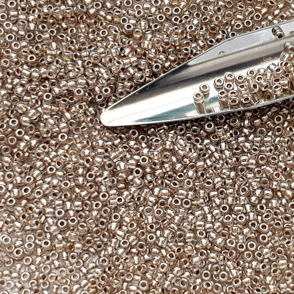 11/0 Toho Seed Beads in Crystal Gold-Lined TR-989 with a beading scoop