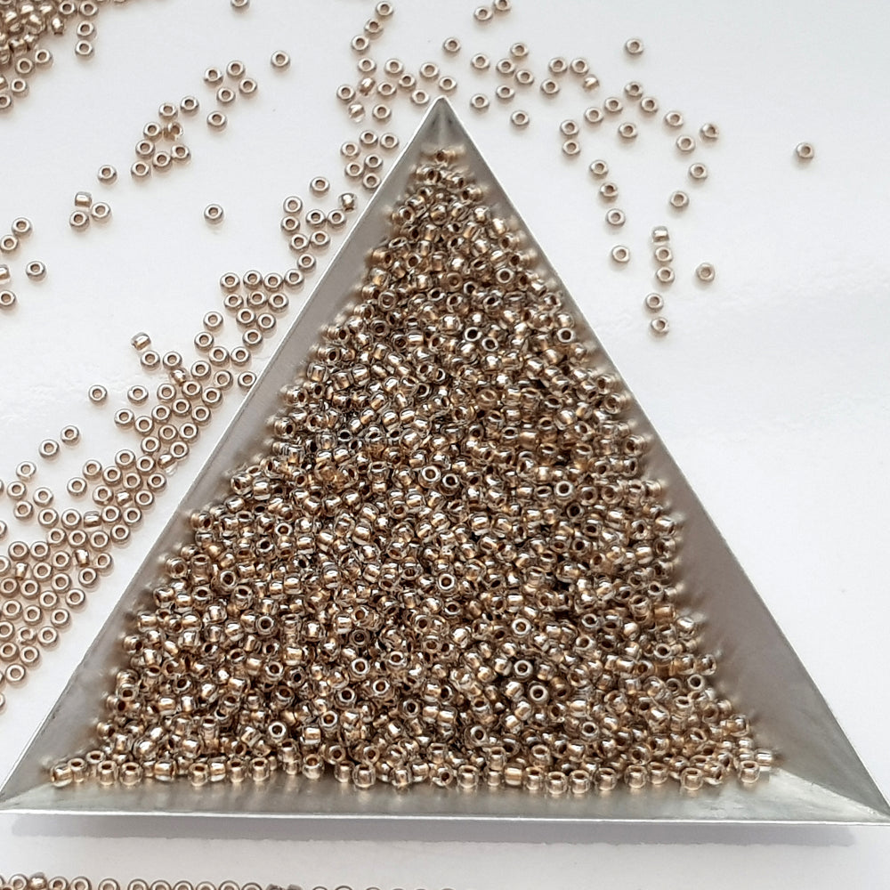 11/0 Toho Seed Beads in Crystal Gold-Lined TR-989 with a triangle scoop.