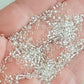 Toho 11/0 Crystal Silver-Lined TR-21 on a hand.
