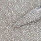 Toho 11/0 Crystal Silver-Lined TR-21 with a beading scoop