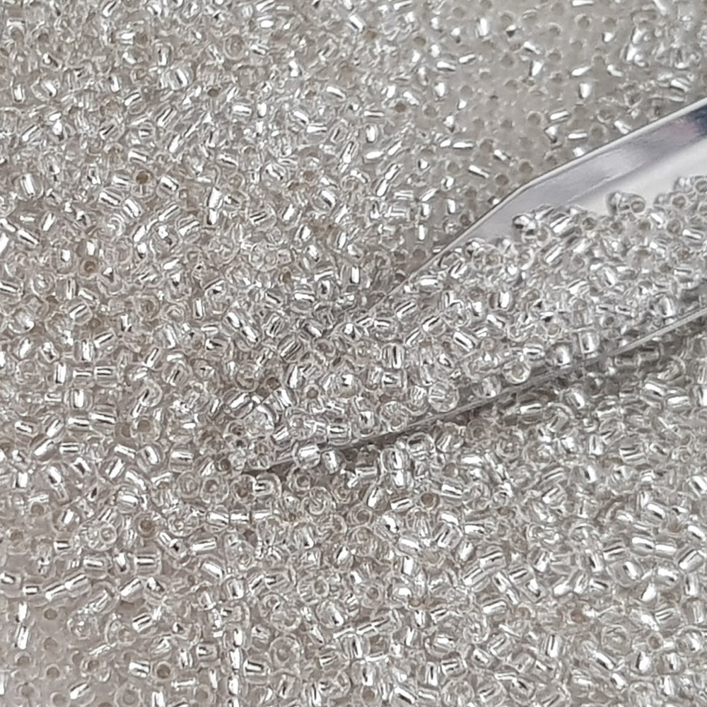 Toho 11/0 Crystal Silver-Lined TR-21 with a beading scoop