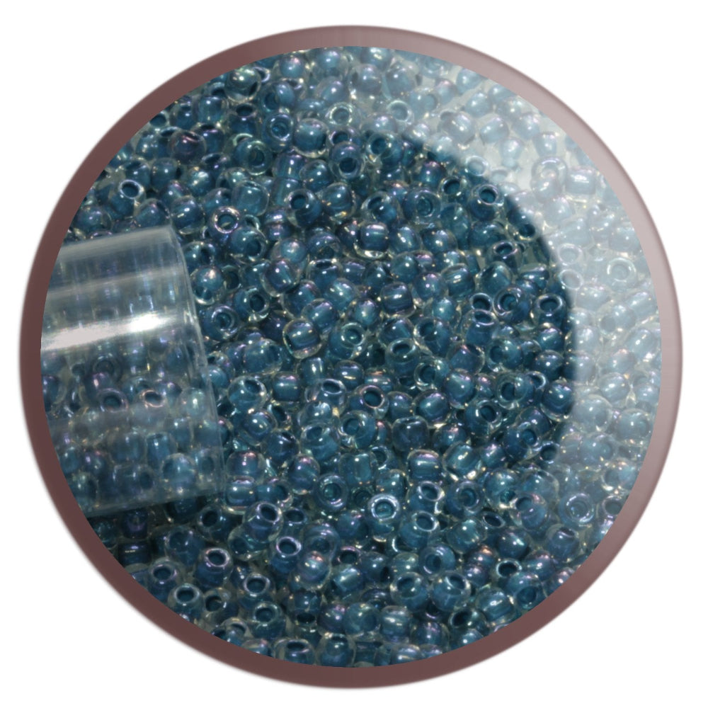 11/0 TR-193 Crystal Lustre Dark Capri Lined Round Toho Seed Beads in a circle white background.