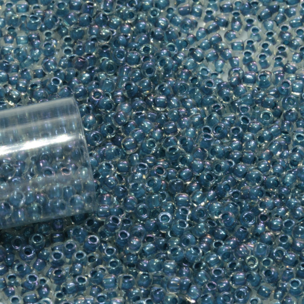 11/0 TR-193 Crystal Lustre Dark Capri Lined Round Toho Seed Beads close up.