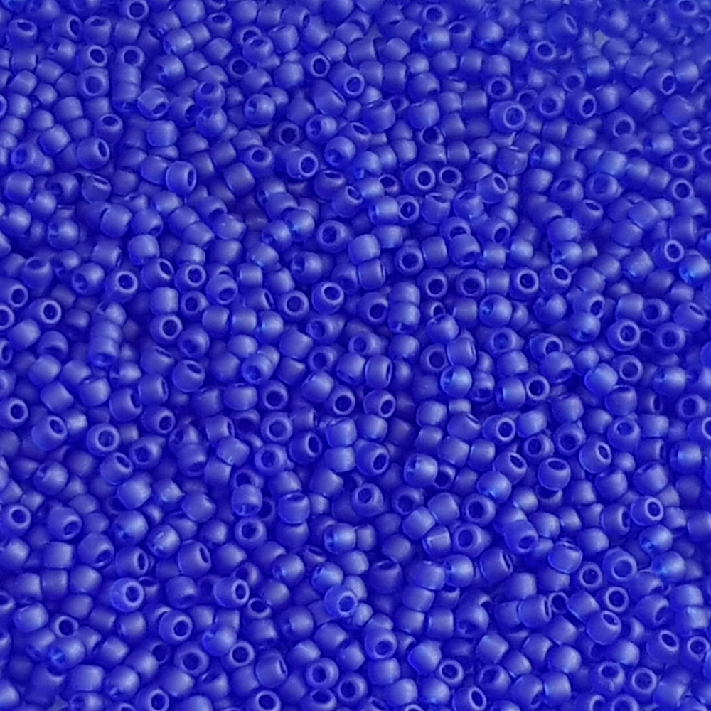 A close-up view of dark sapphire frosted transparent round Toho seed beads 11/0