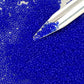 11/0 Toho Seed Beads in Dk sapphire frosted transparent with a beading scoop.