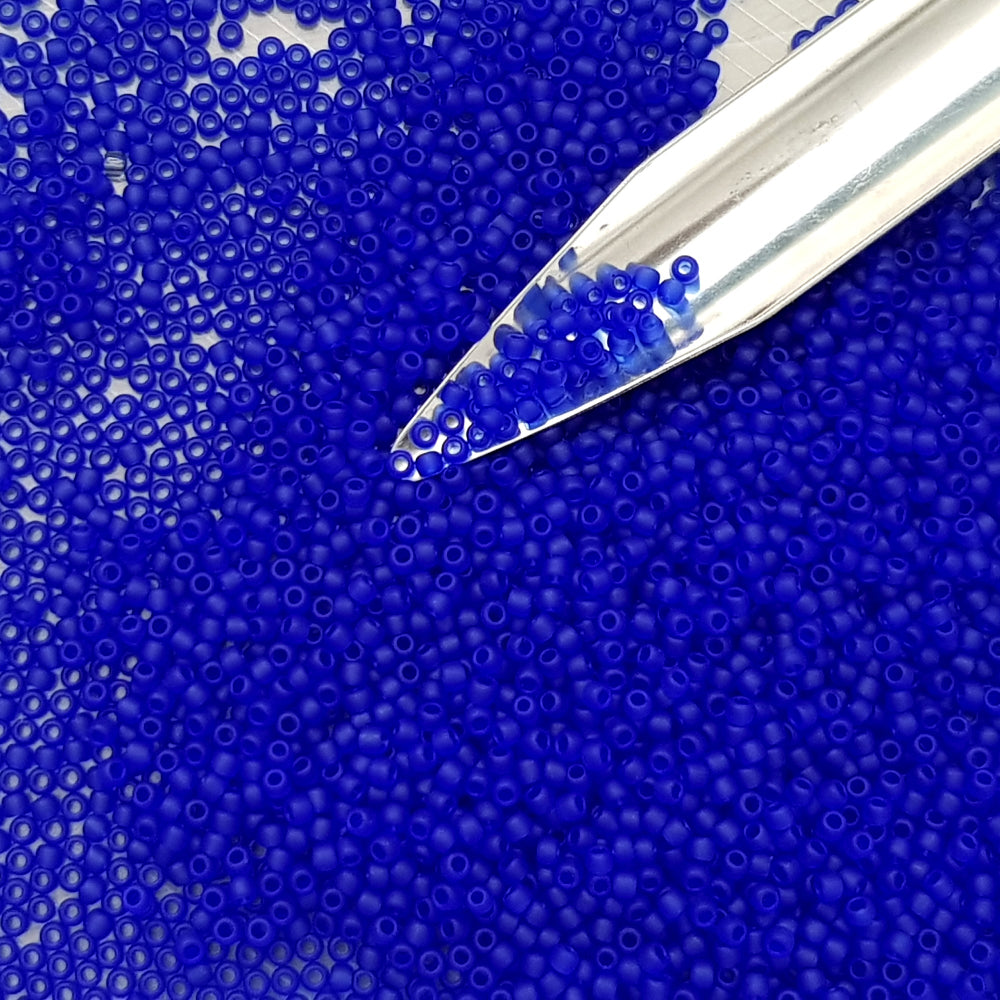 11/0 Toho Seed Beads in Dk sapphire frosted transparent with a beading scoop.