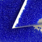 11/0 Toho Seed Beads in Dk sapphire frosted transparent with a triangle scoop.