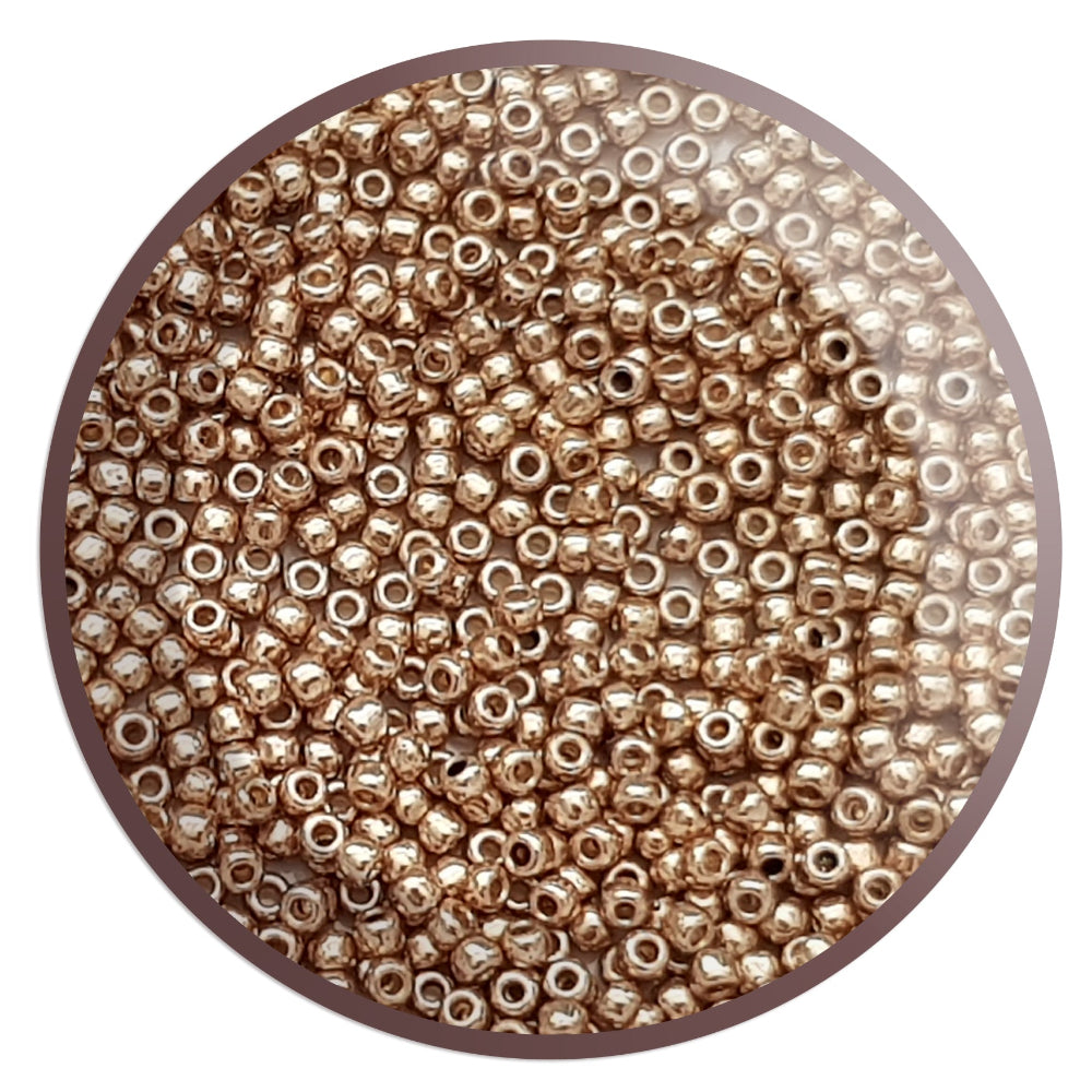 11/0 Toho Seed Beads in Golden Fleece Permanent Finish Tr-PF592 in a circle white background.