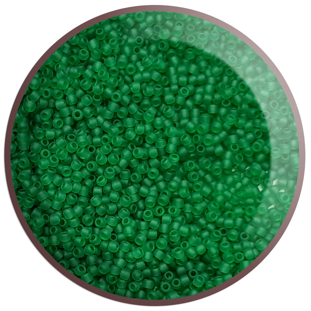 11/0 Toho Seed Beads in grass green frosted transparent TR-7BF in a circle white background.