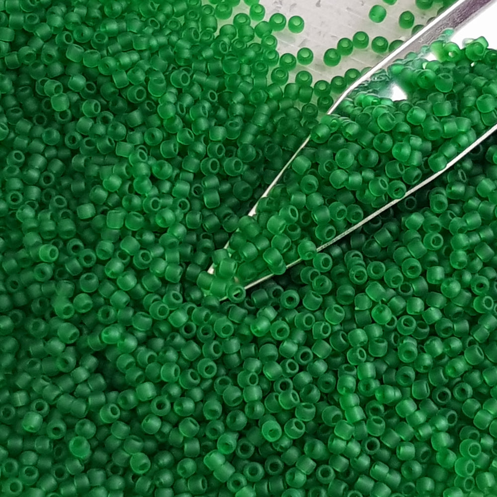 11/0 Toho seed beads in grass green frosted transparent TR-7BF with a beading scoop.