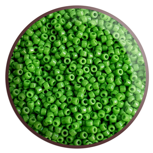 11/0 Toho seed beads in green mint opaque TR-47 in a circle container white background.