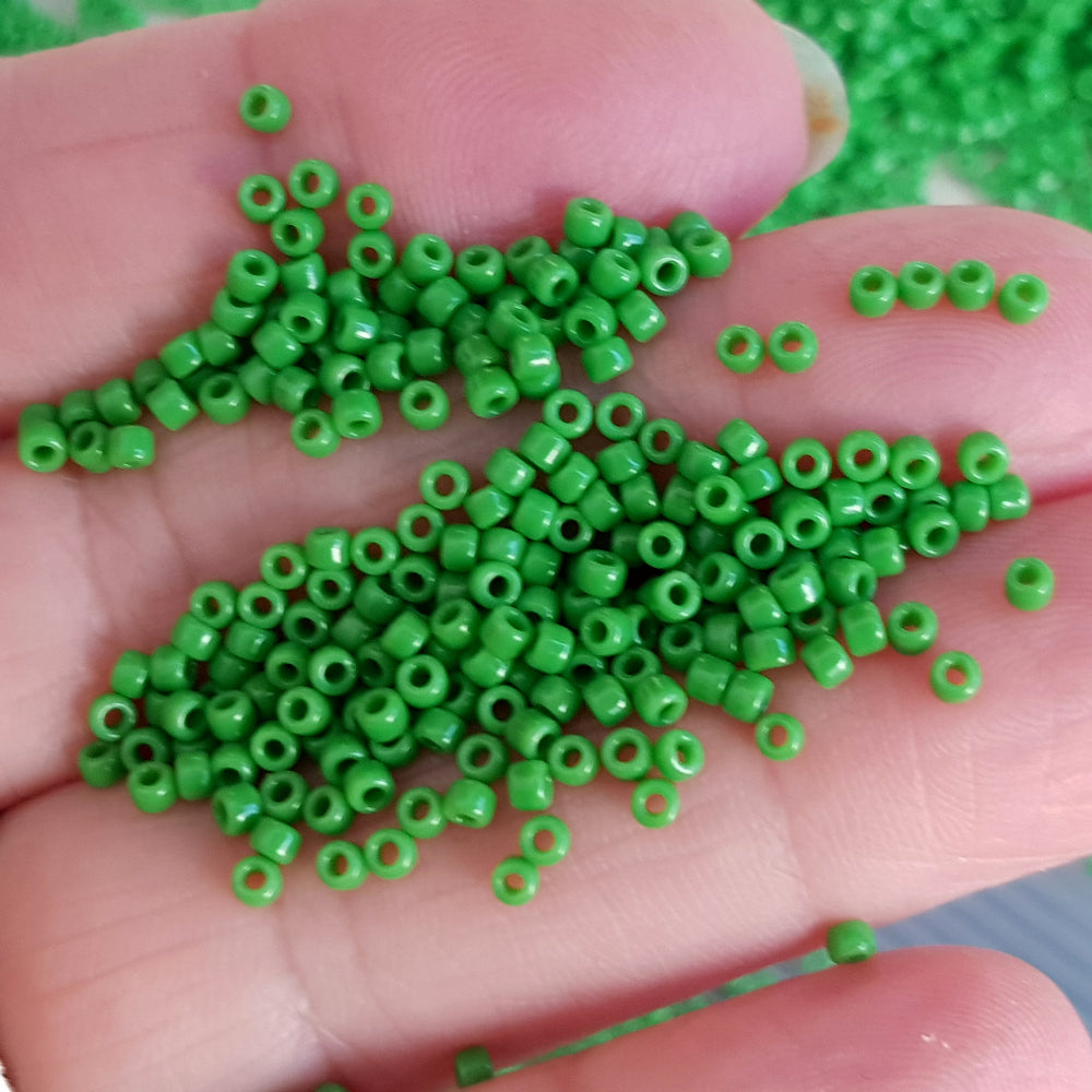 11/0 Toho seed beads in green mint opaque TR-47 on a hand