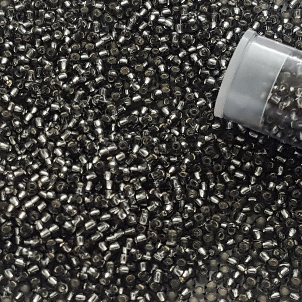 11/0 TR-29B Grey Silver Lined Round Toho close up with the top of a tube.
