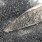 11/0 Toho Seed Beads in grey transparent with a beading scoop.