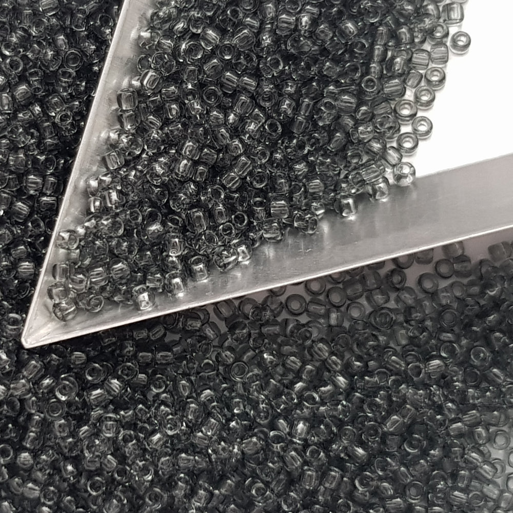11/0 Toho Seed Beads in grey transparent with a triangle scoop.