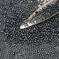 11/0 Toho Seed Beads in Haematite Metallic TR-81 with a beading scoop.