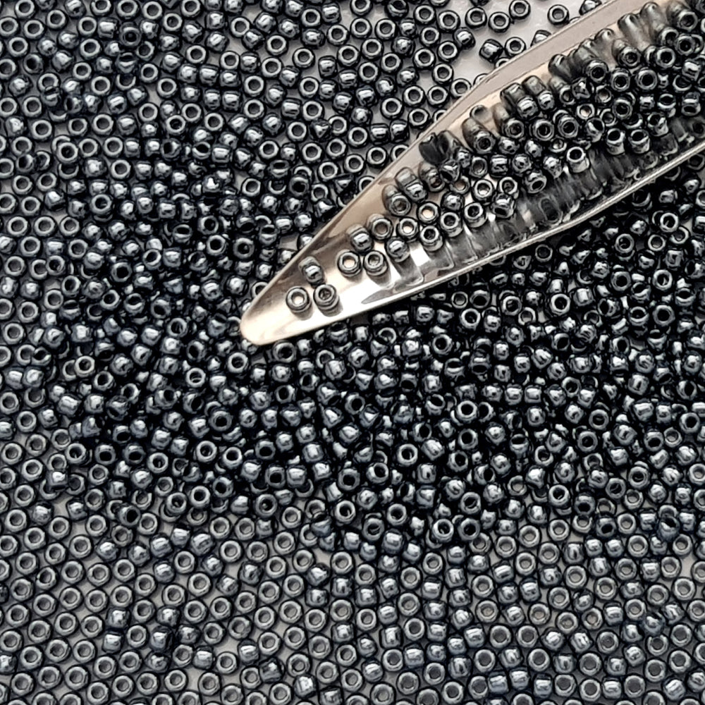 11/0 Toho Seed Beads in Haematite Metallic TR-81 with a beading scoop.