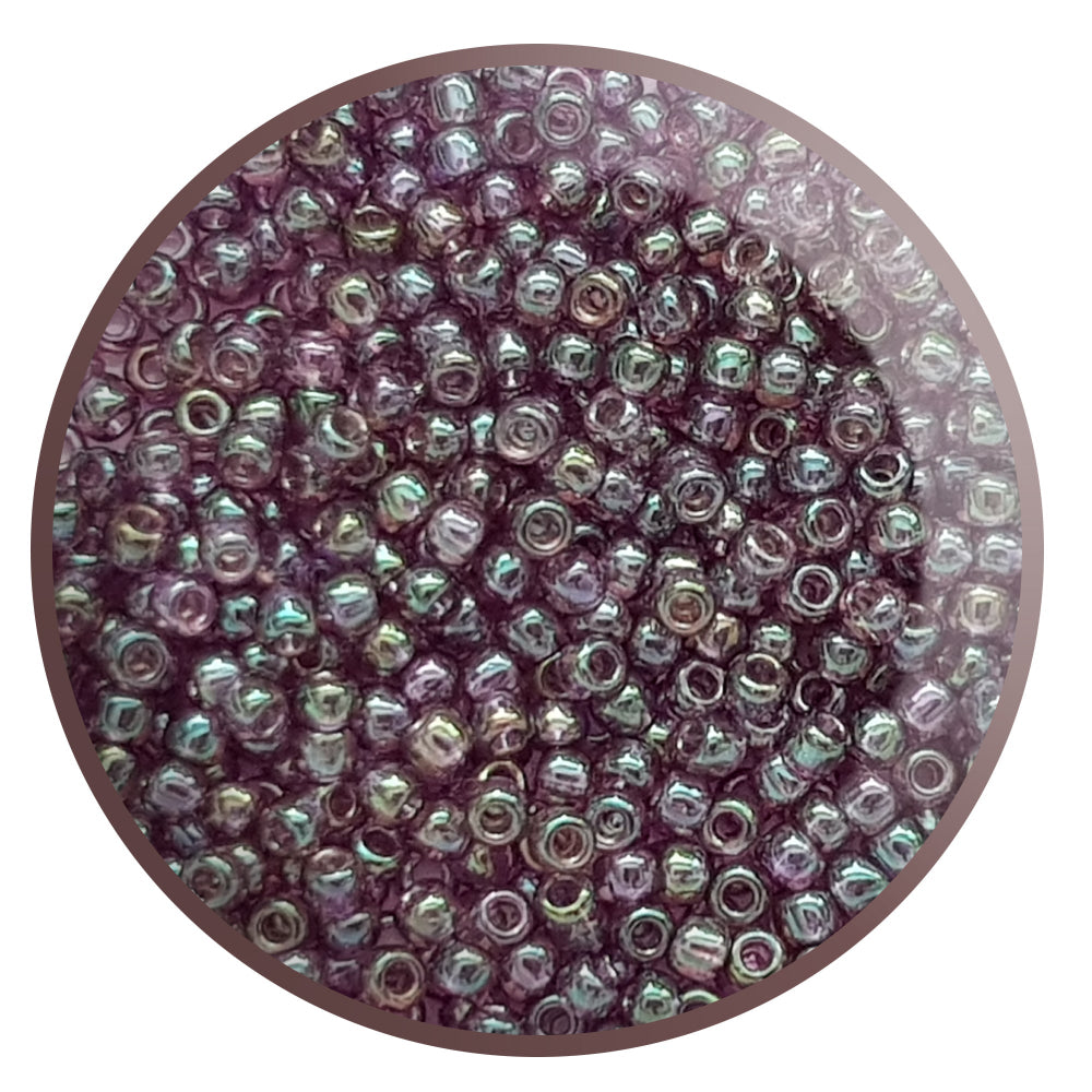 A close-up view of Hydrangea Gold Luster Round Toho Seed Beads 11/0 showing their lustrous finish and multicolored appearance. White background.
