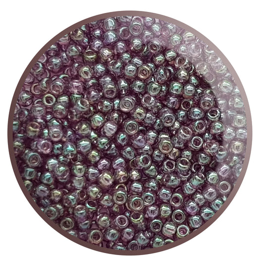 A close-up view of Hydrangea Gold Luster Round Toho Seed Beads 11/0 showing their lustrous finish and multicolored appearance. White background.