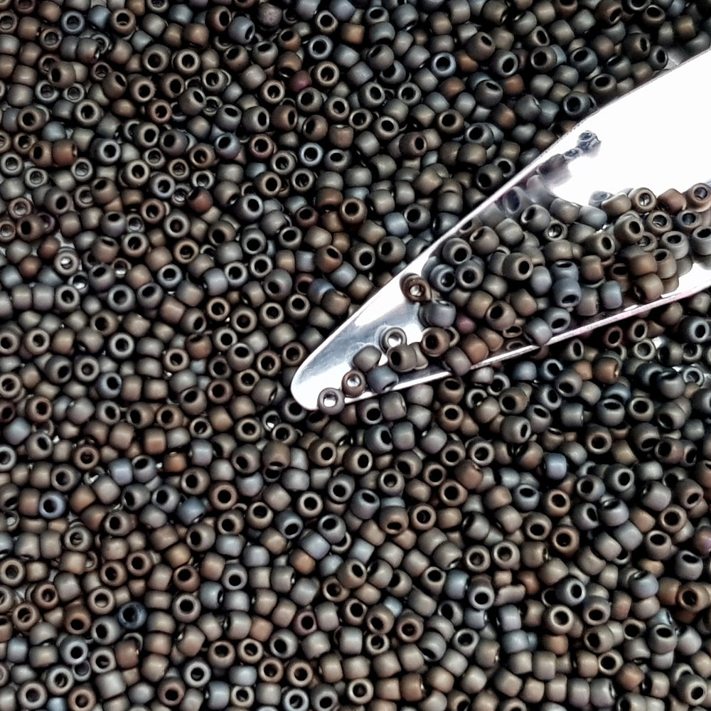 11/0 Toho Seed Beads in Iris Brown Metallic frosted TR-83F with a beading scoop.