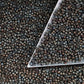 11/0 Toho Seed Beads in Iris Brown Metallic Frosted TR-83F with a triangle scoop.