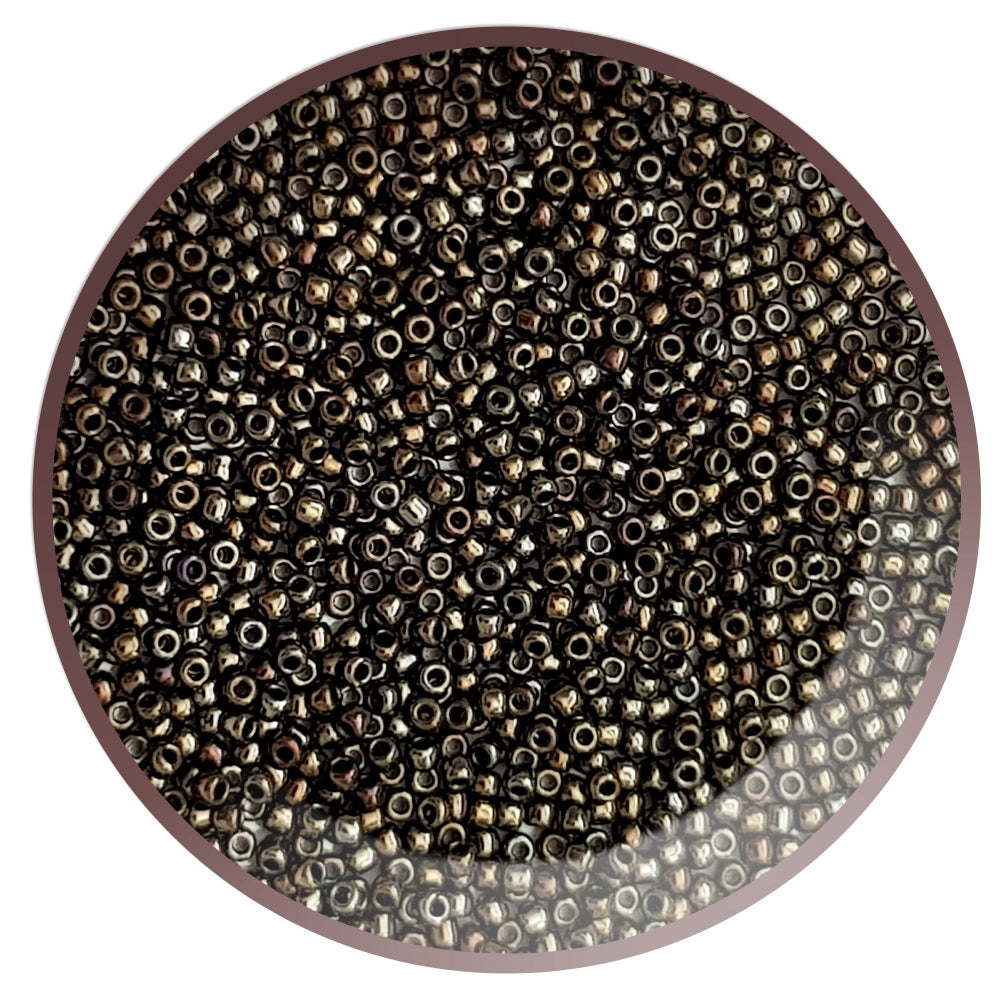 11/0 Toho Seed Beads in Iris Brown Metallic TR-83 in a circle white background