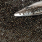 11/0 Toho Seed Beads in Iris Brown Metallic with beading scoop.