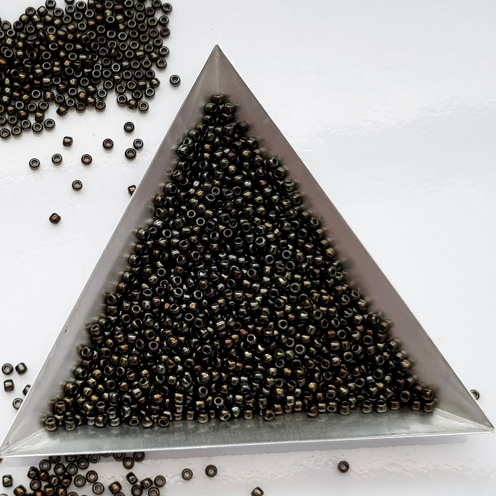 11/0 Toho seed beads in Iris Brown Metallic TR-83 with triangle scoop.