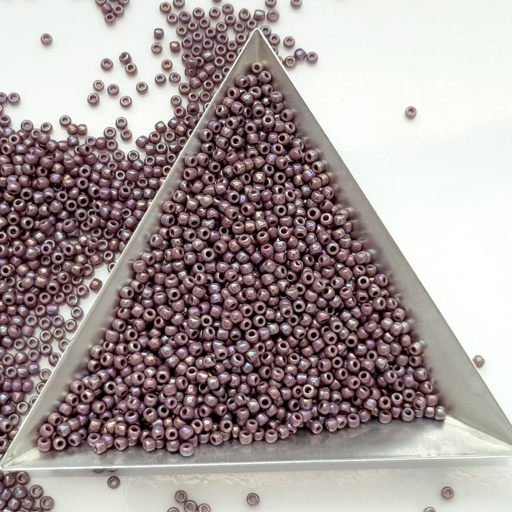 11/0 Toho Seed Beads in lavender rainbow opaque with a triangle scoop.
