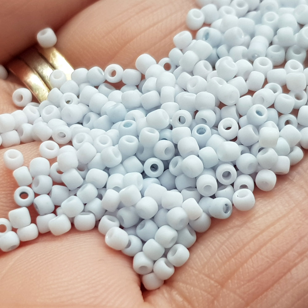A close-up view of light grey frosted opaque pastel round Toho seed beads. 11/0 Toho Seed Beads,
