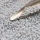 A close-up view of light grey frosted opaque pastel round Toho seed beads. 11/0 Toho Seed Beads, with a beading scoop.
