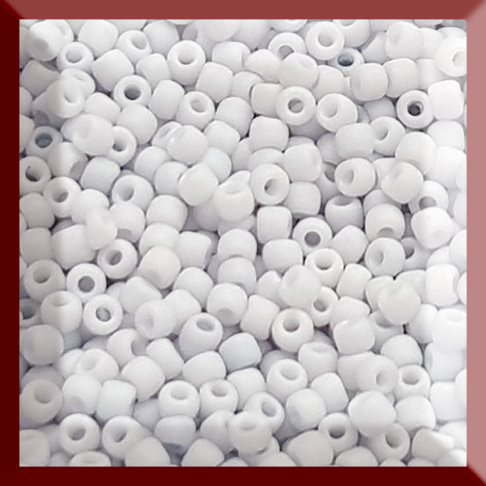 A close-up view of light grey frosted opaque pastel round Toho seed beads. 11/0 Toho Seed Beads, square window.
