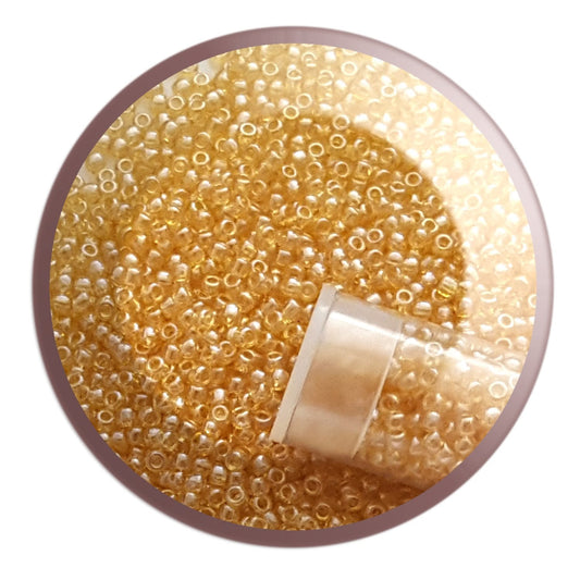 11/0 TR-103 Light Topaz Luster -  Round Toho Seed Beads circle white background.