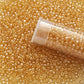 11/0 TR-103 Light Topaz Luster  Round Toho Seed Beads Close Up with a top of a tube