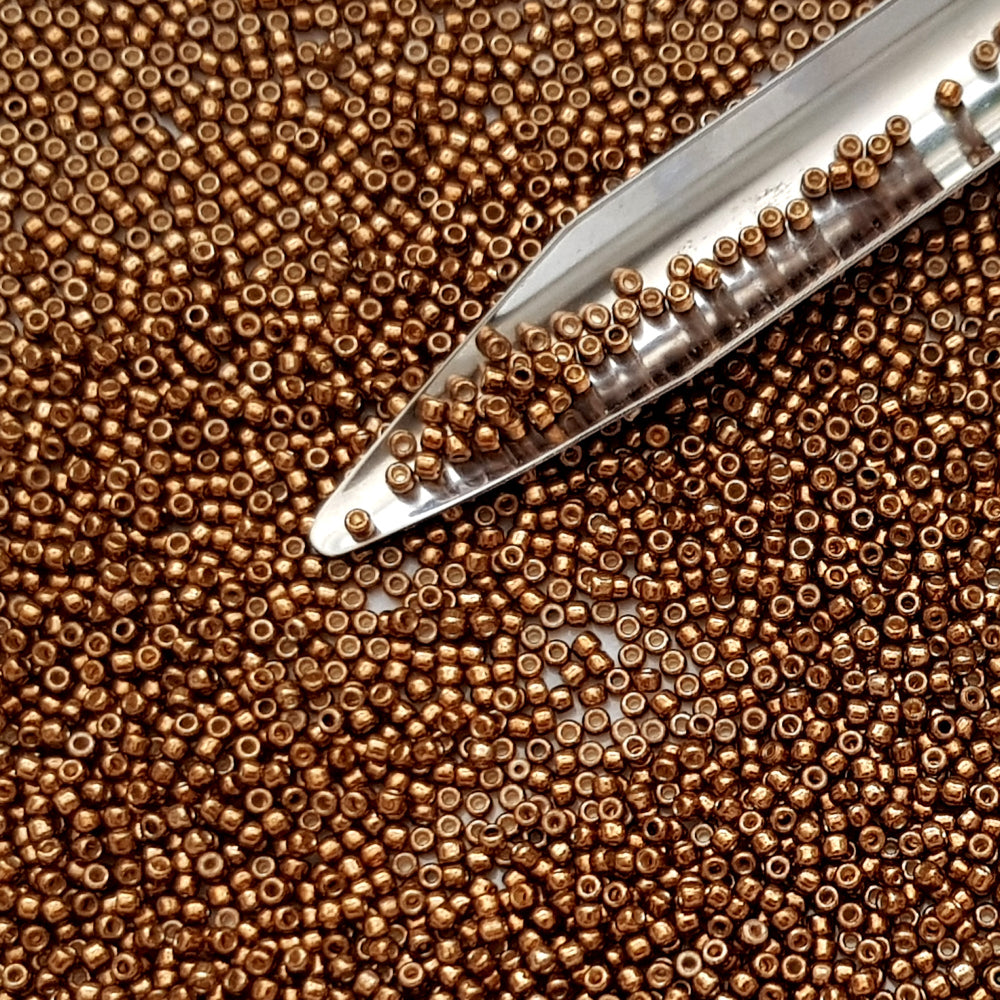 11/0 Toho seed beads in medal bronze galvanized permanent finish TR-PF594 with a beading scoop.