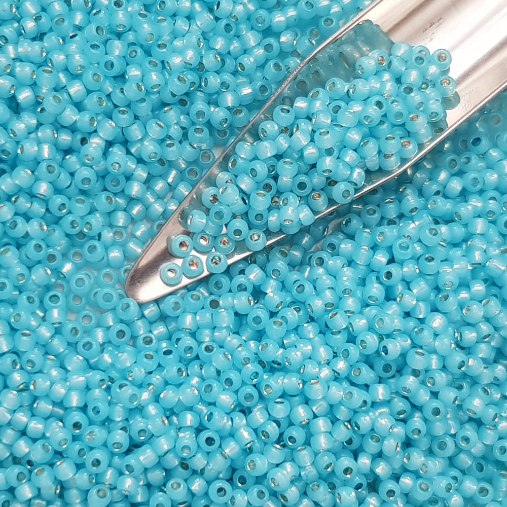 11/0 Toho seed beads in milky aqua silver-lined with a beading scoop.