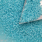 11/0 Toho seed beads in milky aqua silver-line with a triangle scoop.